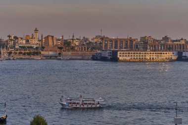 Luxor ,Egypt sunset shot from west bank showing Nile river with  Feluccas, cruise ships  and Luxor Temple in East bank