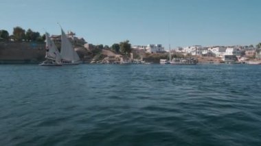 Nile river in Aswan, Egypt afternoon shot showing feluccas and boats in the river with elephantine Island (UNESCO World Heritage site)