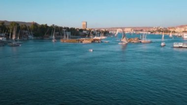 Nile river in Aswan, Egypt afternoon shot showing feluccas and boats in the river with elephantine Island (UNESCO World Heritage site)