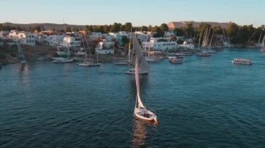 Nile river in Aswan, Egypt afternoon shot showing feluccas and boats in the river with elephantine Island (UNESCO World Heritage site)