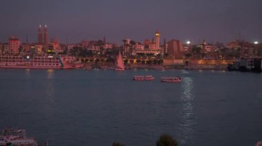 Luxor ,Egypt night shot from west bank showing Nile river with  Feluccas and Luxor Temple in East bank