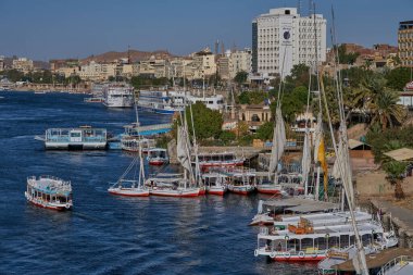 Nile river in Aswan, Egypt afternoon shot showing feluccas and boats in the river with elephantine Island (UNESCO World Heritage site)