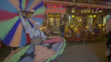 Mısır Folklorik Tanoura Dansçısı Kahire, Mısır 'daki al-Muizz Caddesi' nde gece canlı performans sergiliyor.