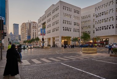 Msheireb Downtown Doha, Qatar afternoon shot showing the unique architecture of the buildings with people and cars in the street clipart