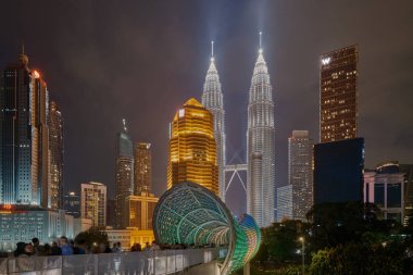 Saloma Link bridge in Kuala Lumpur, Malaysia is 69 meters combined pedestrian and bicyclist bridge across the Klang River in Kuala Lumpur. Night shot clipart