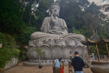 Large statue of Buddha in The Chin Swee Caves Temple in Genting Highlands, Pahang, Malaysia a Chinese temple situated in most scenic site of Genting clipart