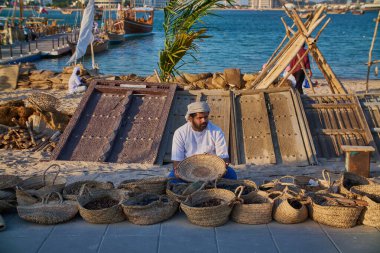 A Traditional Arabic fisherman sitting in Katara beach in Doha, Qatar afternoon shot during Katara 14th traditional dhow festival clipart