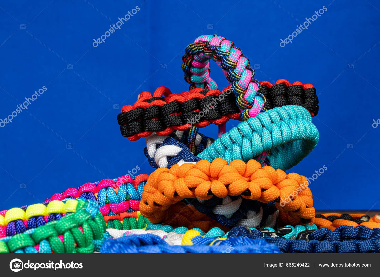 Lots Braided Paracord Bracelets Blue Background Handmade Creative Design  Stock Photo by ©Aikilu 665249422