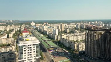 Obolon, Kyiv, 09052020. Güneşli bir sonbahar gününde şehrin uyku alanı. Konut binaları, kilise, toprak seti. İHA videosu 4K.