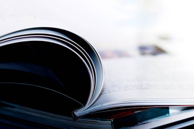 Masanın üzerinde açık bir kitap. Sığ bir alan derinliği olan bir noktaya odaklan.