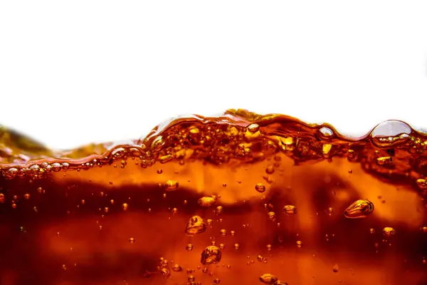 Cola drink splashing with bubbles On a white background, isolated