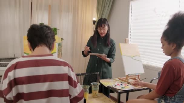 Female Asian Teacher Teaches Demonstrates Children Acrylic Color Picture Painting — Stock Video