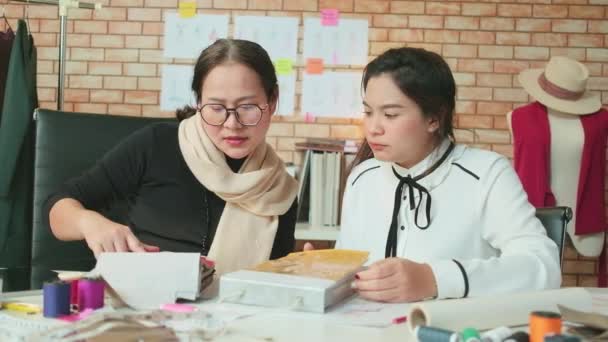 Asian Middle Aged Female Fashion Designer Teaches Young Teen Trainee — Video