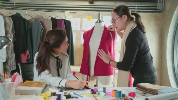 Asiatische Modedesignerin Mittleren Alters Unterrichtet Junge Teenie Trainee Schneiderin Über — Stockvideo