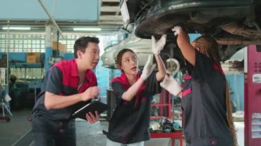 Professional automotive supervisors' teams inspect repair work with female African American mechanic worker at a car garage, service maintenance, and fix specialist occupations in the auto industry.