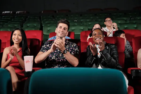 Various people in theater. Multiracial audiences, Black woman, and friends enjoy watching cinema and applauding together on movie shows, entertainment lifestyle with film, happy and cheerful smiles.