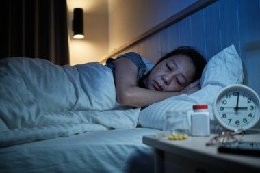 Orta yaşlı kadın Asya 'da uyku bozukluğu var, stresli ve geceleri uykusuzluk, yatak odasında uykusuzluk hastalığı, olgun ve menopoz hastası kadınların sağlık sorunları yüzünden uykusuzluk çekiyor..