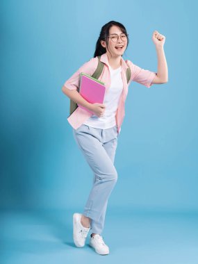 Mavi arka planda genç Asyalı öğrenci