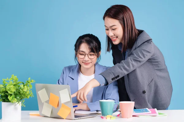 Two Asian businesswoman working background