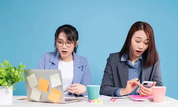 Two Asian businesswoman working background