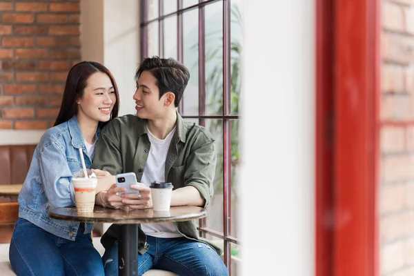 stock image Young Asian couple dating at coffee shop
