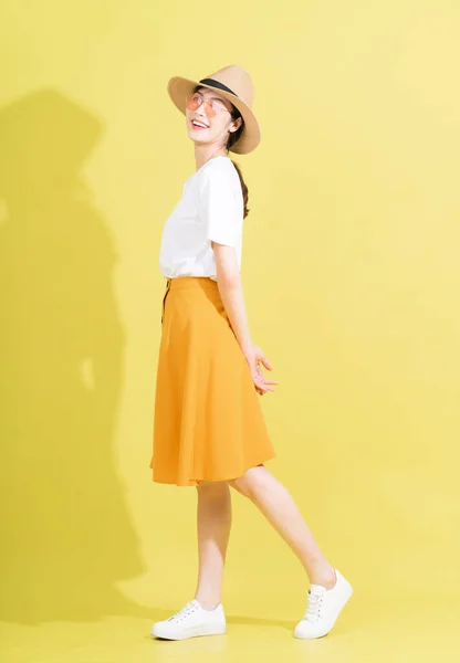 stock image Full length photo of young Asian girl on yellow background