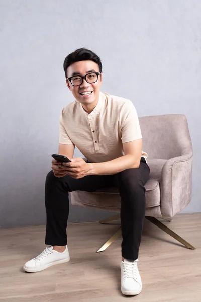 stock image Image of young Asian man sitting on chair