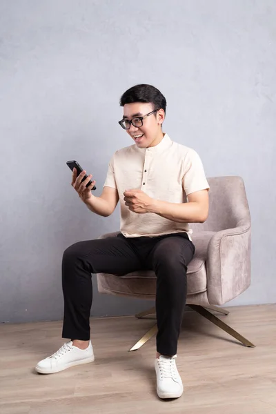 stock image Image of young Asian man sitting on chair