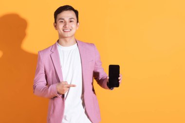 Arka planda poz veren Asyalı genç bir adamın portresi