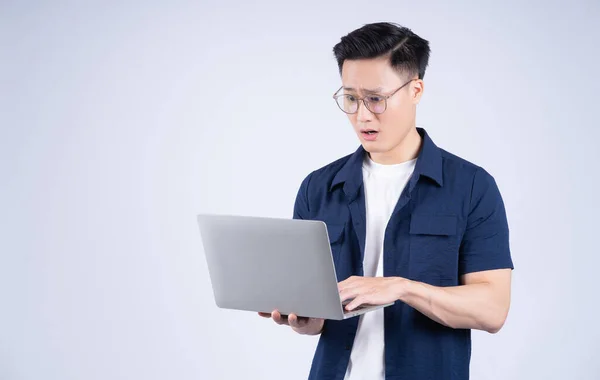 Stock image Young Asian man using laptop on white background