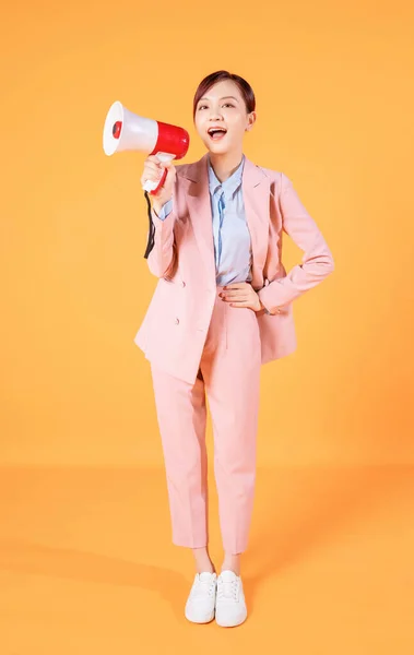 stock image Photo of young Asian businesswoman holding megaphone on background