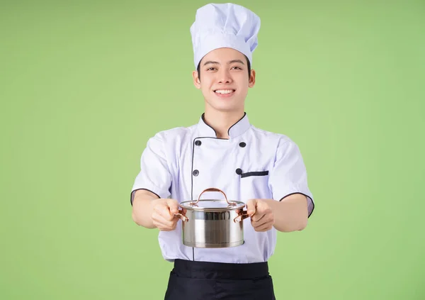 stock image Photo of young Asian male chef on background