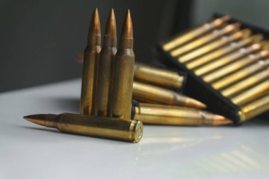 Close-up of ammunition for an assault rifle. Small-caliber ammunition for small arms. clipart
