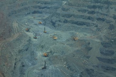 Madencilerin çıkarılması için bir taş ocağında maden çıkarma işlemi. Büyük ekipmanların yardımıyla demir madenciliği, çukur kasesi. 