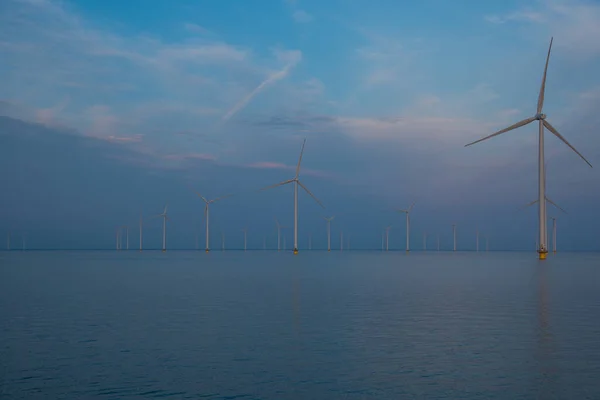 Stock image wind power station in the north sea at sunset