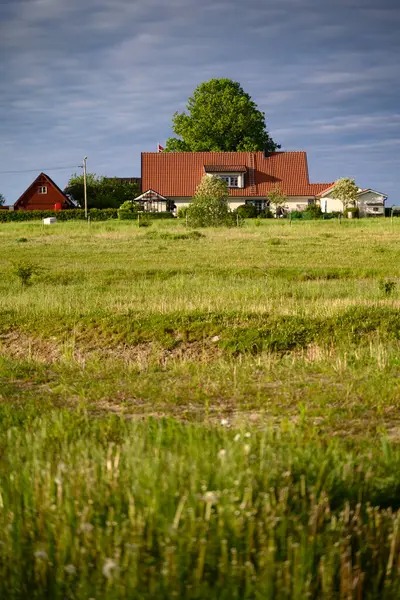 Tarlada bir çiftlik evi. Kırsal alan, kara bulutlar, Skane, İsveç. Yüksek kalite fotoğraf