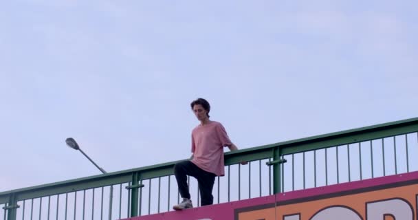 Guy Raises His Foot Advertising Reckoning Stands Bridge Ready Jump — Stock Video