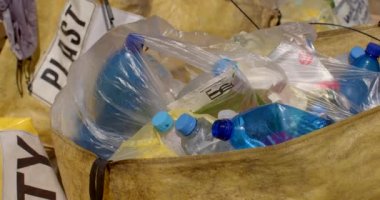 Plastic trash lies in a pile. He moves with the wind. Accumulation of household waste for recycling. Yellow container dirty stains. Unsanitary conditions. CZ, Milovice, 7.8.22 Let it Roll