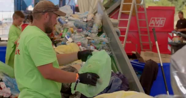 Ensure Reuse Male Worker Sorts Garbage Landfill Selects Plastic Bags — Stock video