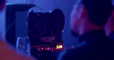 Babin movement on an analog tape recorder at a concert. Recording sound on old media to create sound recording effects. Mixer knobs in the light. CZ, Prague, Zizkov, 10.12.22.