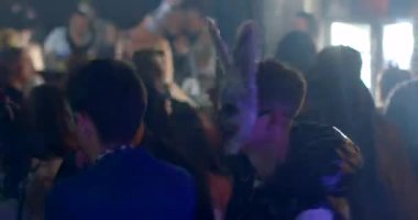 A guy in a hare mask is dancing in a nightclub. He moves his body and arms. Flashing lights disco atmosphere. CZ, Prague, Republici, 30.10.22