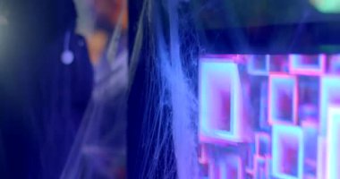 The movement of a coloured abstract pattern in the monitor. The interior of the dance floor in a nightclub. Cobweb dust on the corner of the device, creating the atmosphere of a Halloween party.