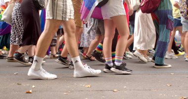 Slow movement of people on foot. Celebrating LGBTQ culture and the acceptance of people belonging. Legs of crowd people during the Pride parade procession. 13.08.2022 Parizska, Prague, CZ