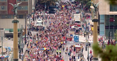 Panorama of the city crowd of people LGBT parade in the city. The movement of the column with the flag. Use of the roadway for pedestrians. 13.08.2022 Parizska, Prague, CZ