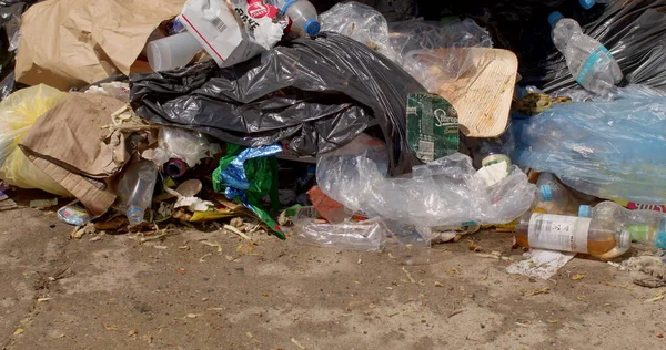 Garbage dump near human habitation. Pollution of the environment with waste products of non-biological solid household waste. Broken black waste bags. CZ, Milovice, 7.8.22 Let it Roll