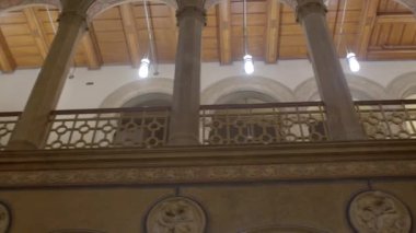 The interior of the old building has high ceilings, columns, concrete ceilings. A dark room. DE, Berlin, Branderburger, 16.1.23.