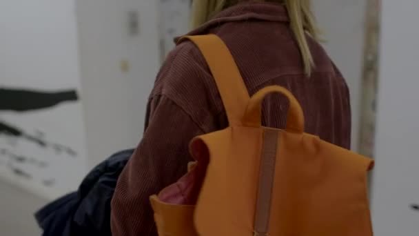Shoulder Girl Carries Backpack Dark Room Brown Fabric Attracts Attention — Video