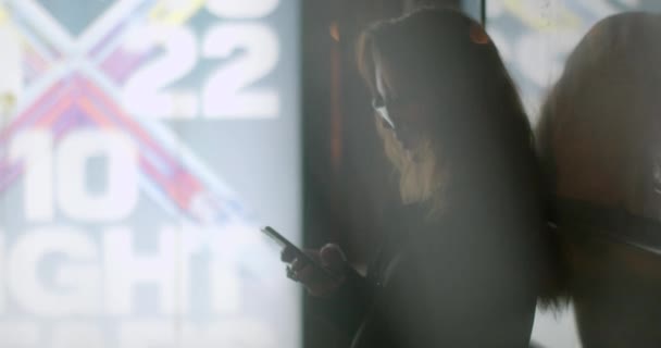 Girl Glasses Using Phone Her Hands Night Stop She Looks — Vídeos de Stock