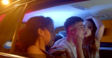 The movement of passengers in the car in the tunnel of the city. An African-American woman dances in bokeh, moves her arms, a guy with girls sings. Road to the party.