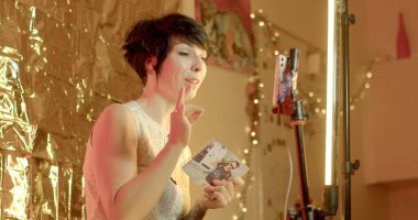 She uses an online smartphone to record videos. Moves the body, creates emotion. Create an online book review with photos. 